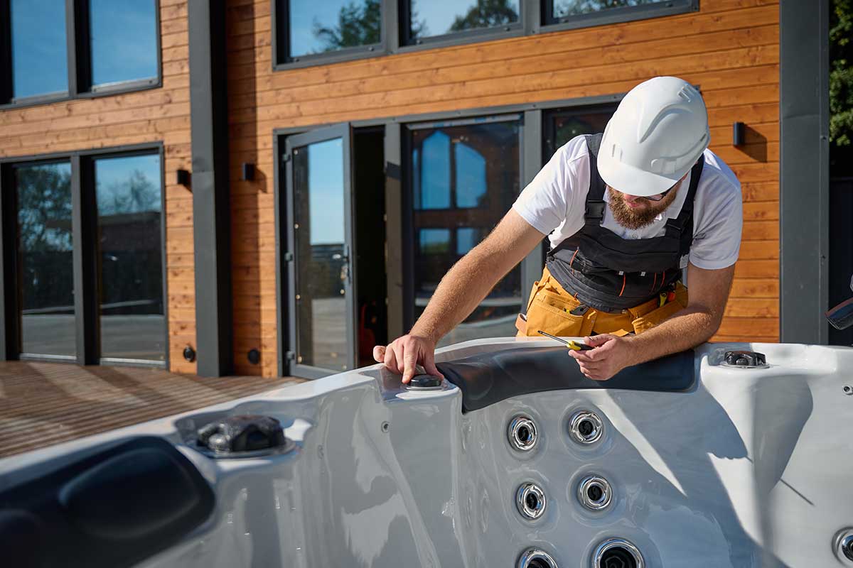 Hot Tub technician inspecting settings - empire pool and patio Hot Tub technician inspecting settings - empire pool and patio